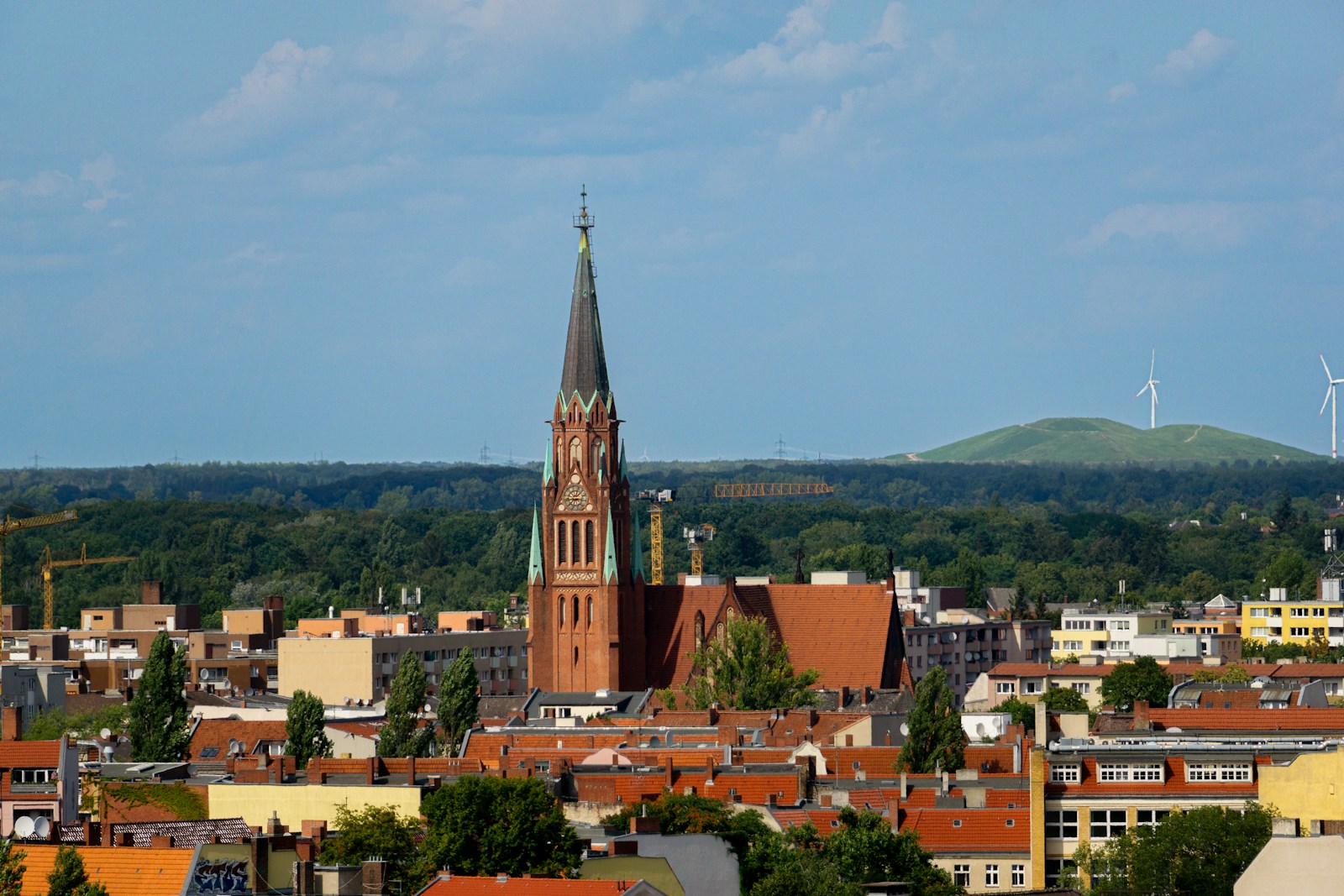 Photo by Robert Schwarz a view of a city with a church steeple